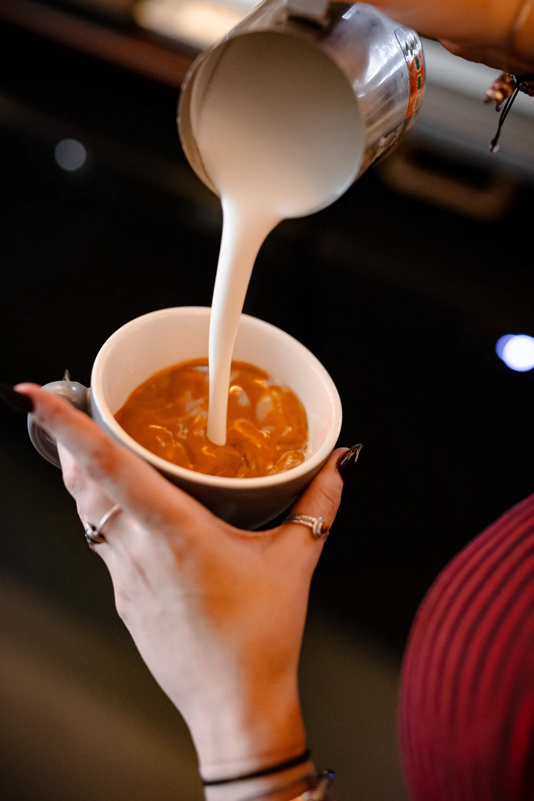 Milk poured into a coffee at Residence