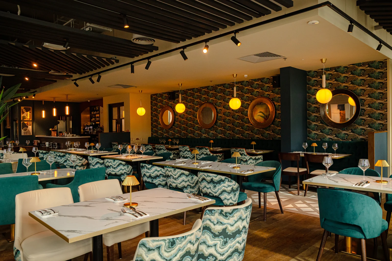 Tables and turquoise seating in the Uyare dining room